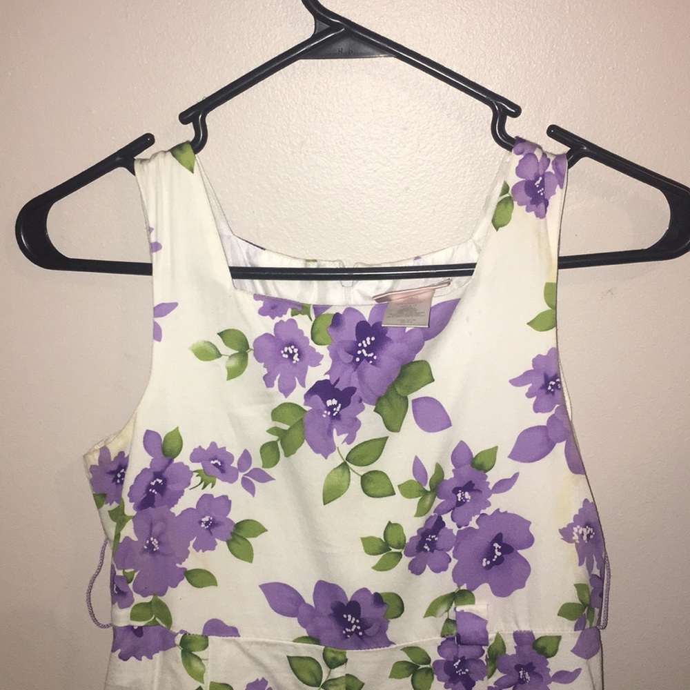 a white dress with a purple floral design.